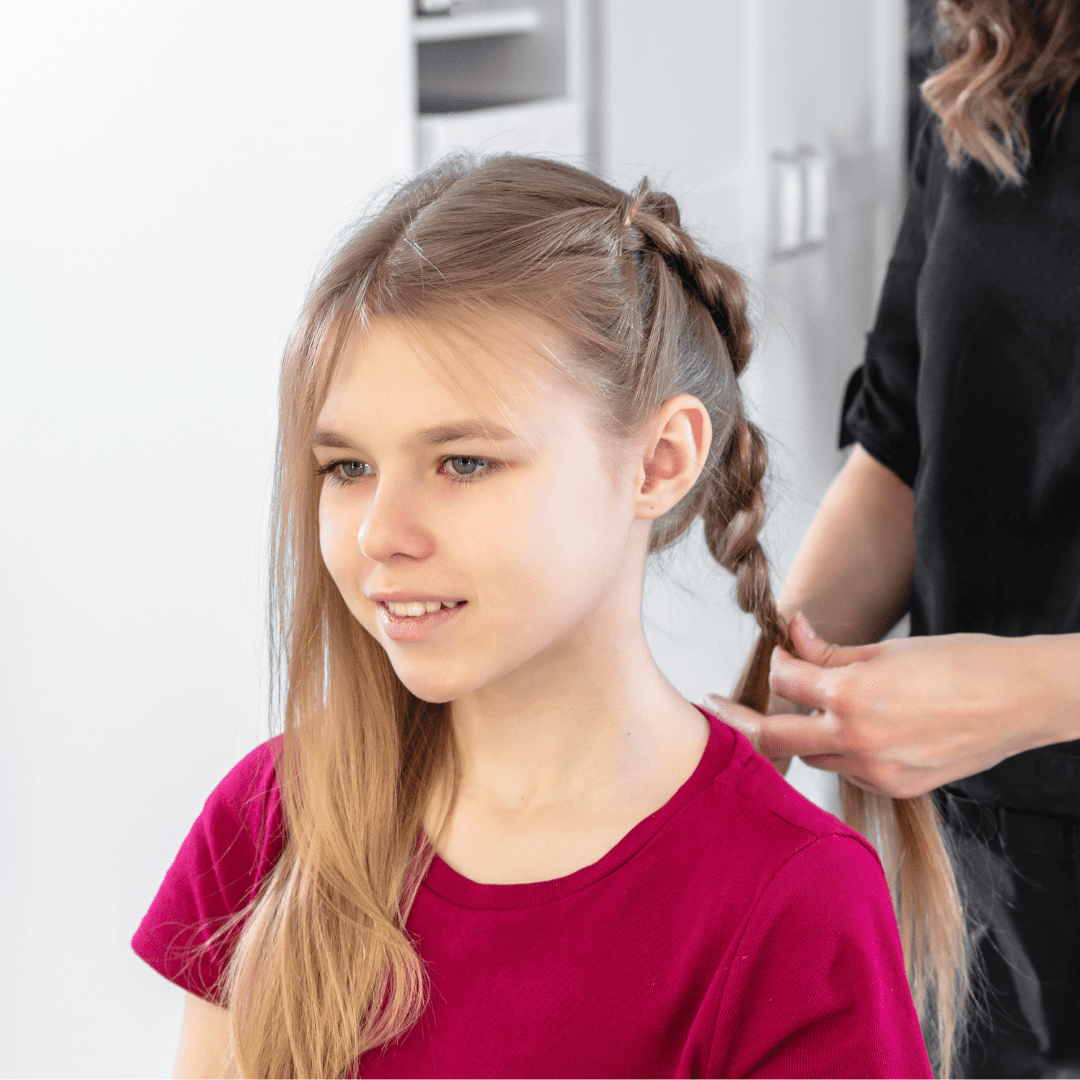 young girl getting braids done