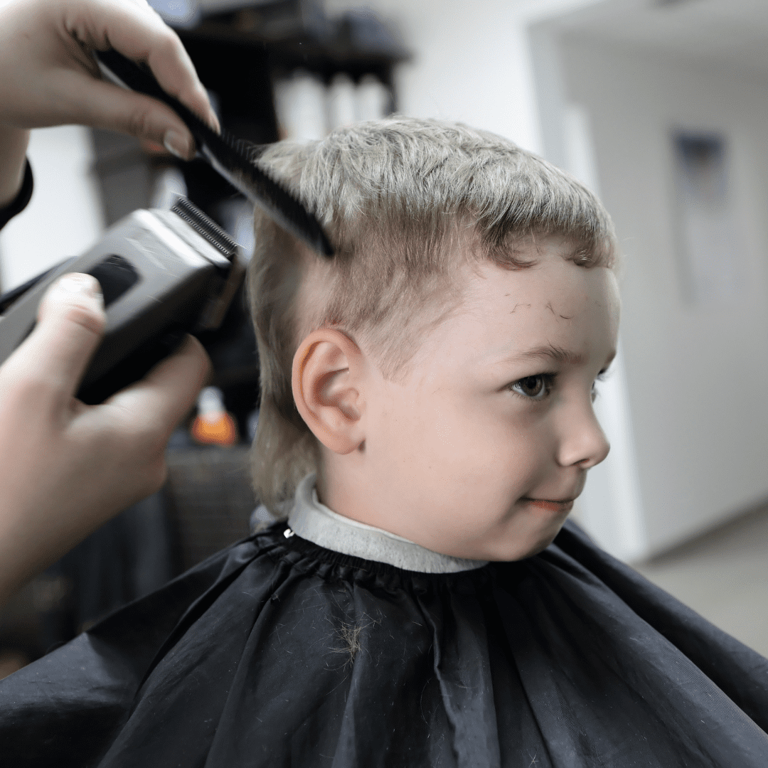 young boy getting haircut
