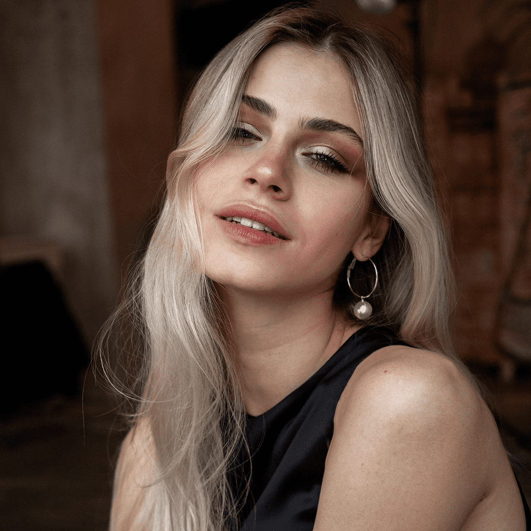 woman with blonde hair and makeup smiling