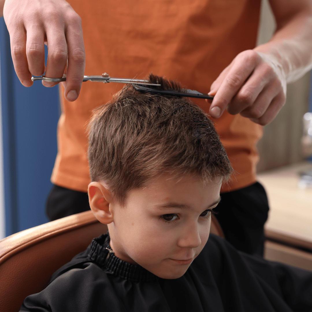 young boy child getting a haircut