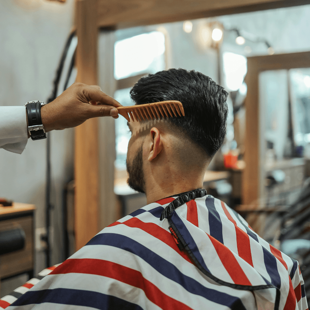 sideview of taperfade hair style man in salon chair