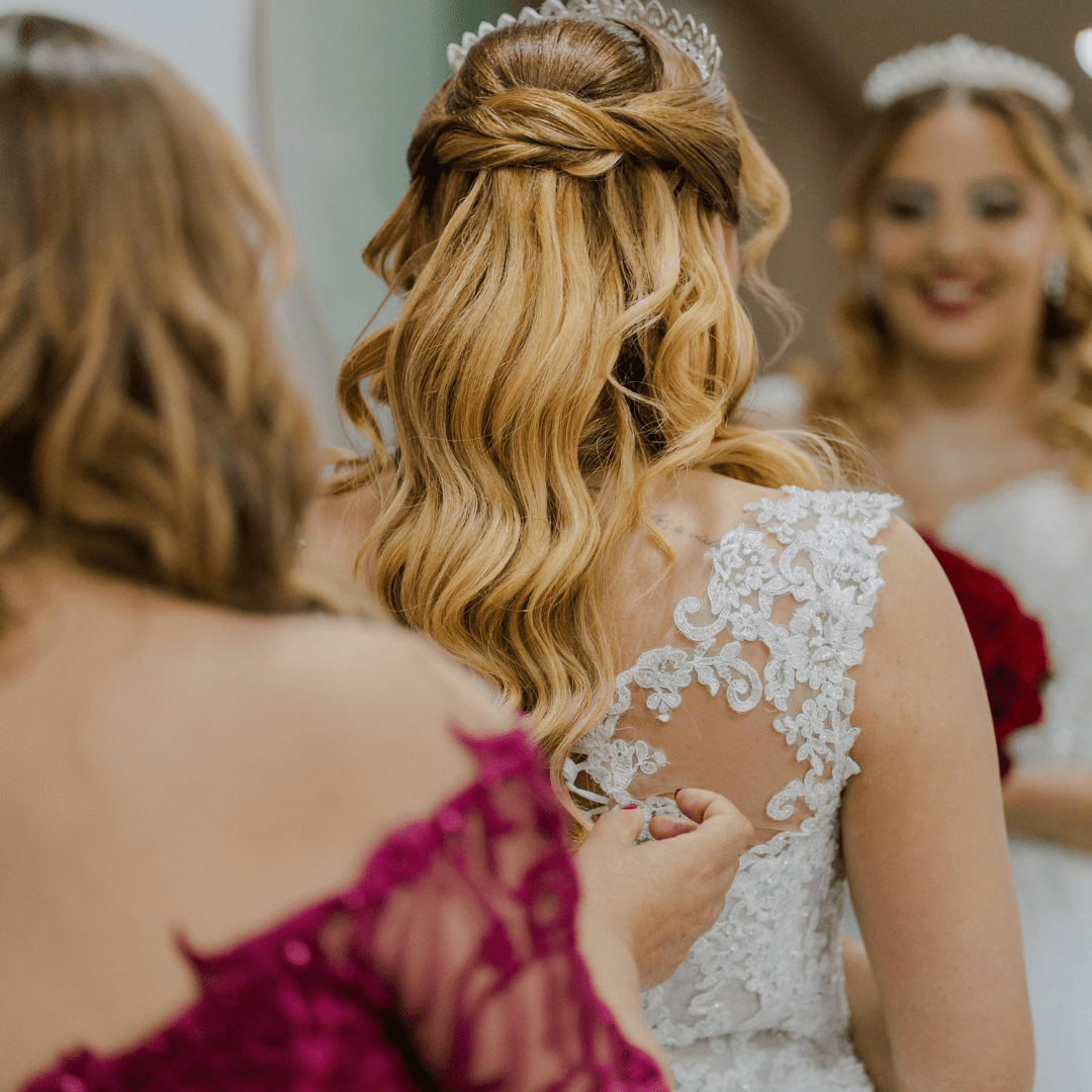 woman in wedding attire looking at reflection in mirror